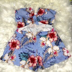 A blue striped, floral print romper with cut out.